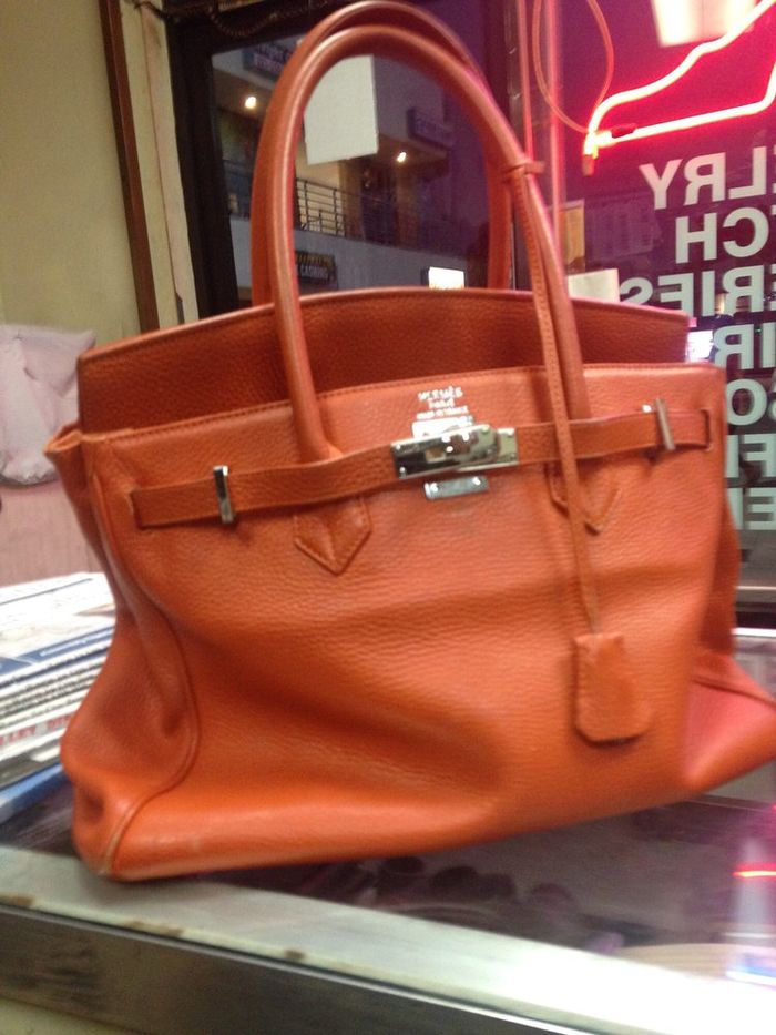 An orange leather handbag on our counter