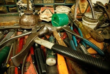 A pile of well-used cobbler's tools on our workbench